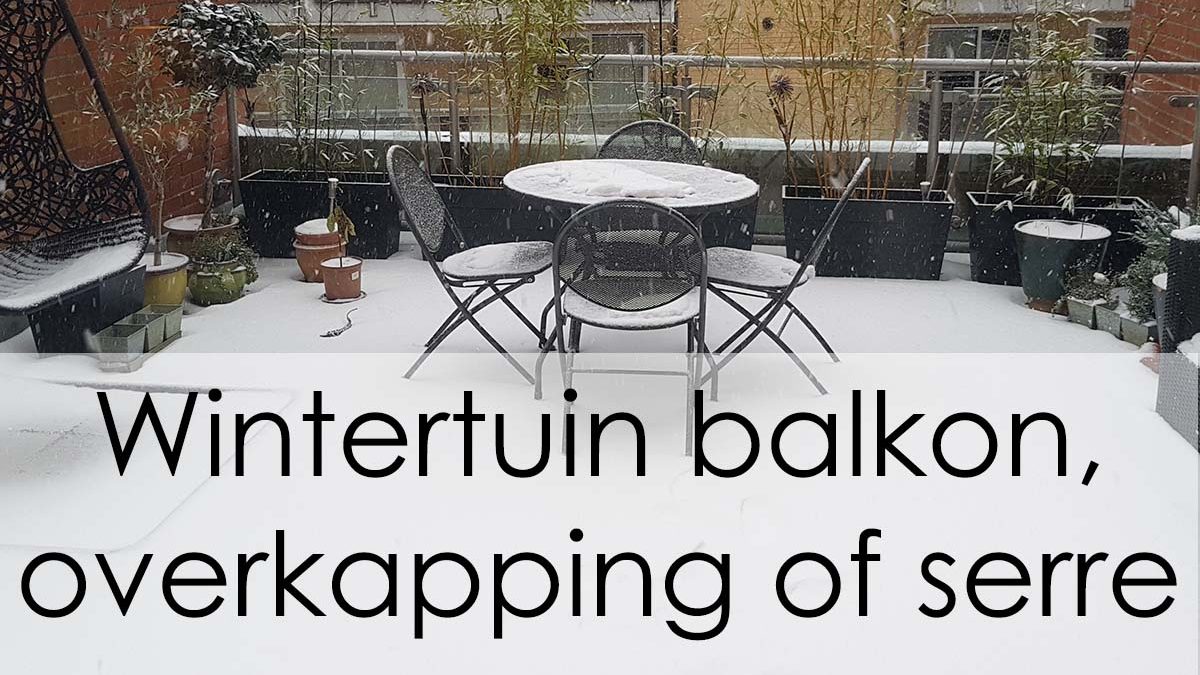 Stadsbalkon / wintertuin tijdens de winter bedekt met sneeuw, met tafel, stoelen en een buitenbank
